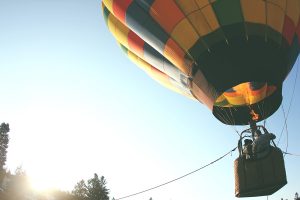 Hot air balloon in flight with two passengers.